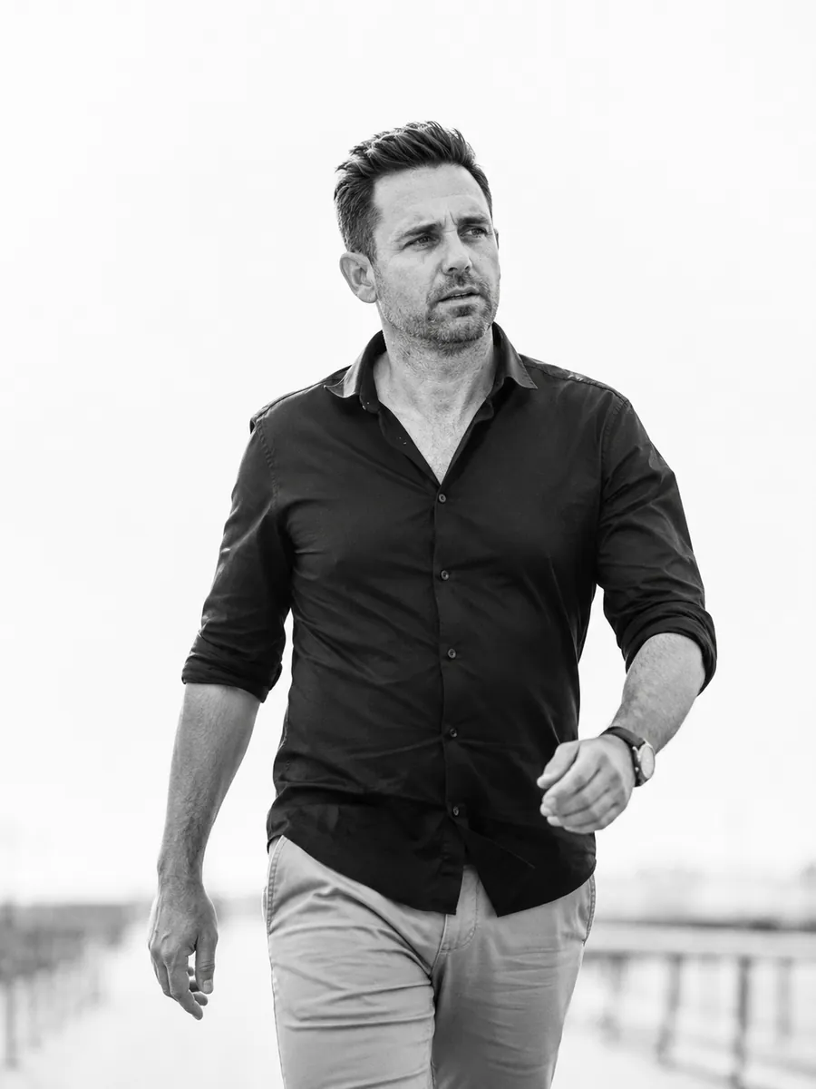 A business owner walking outdoors to get his energy back