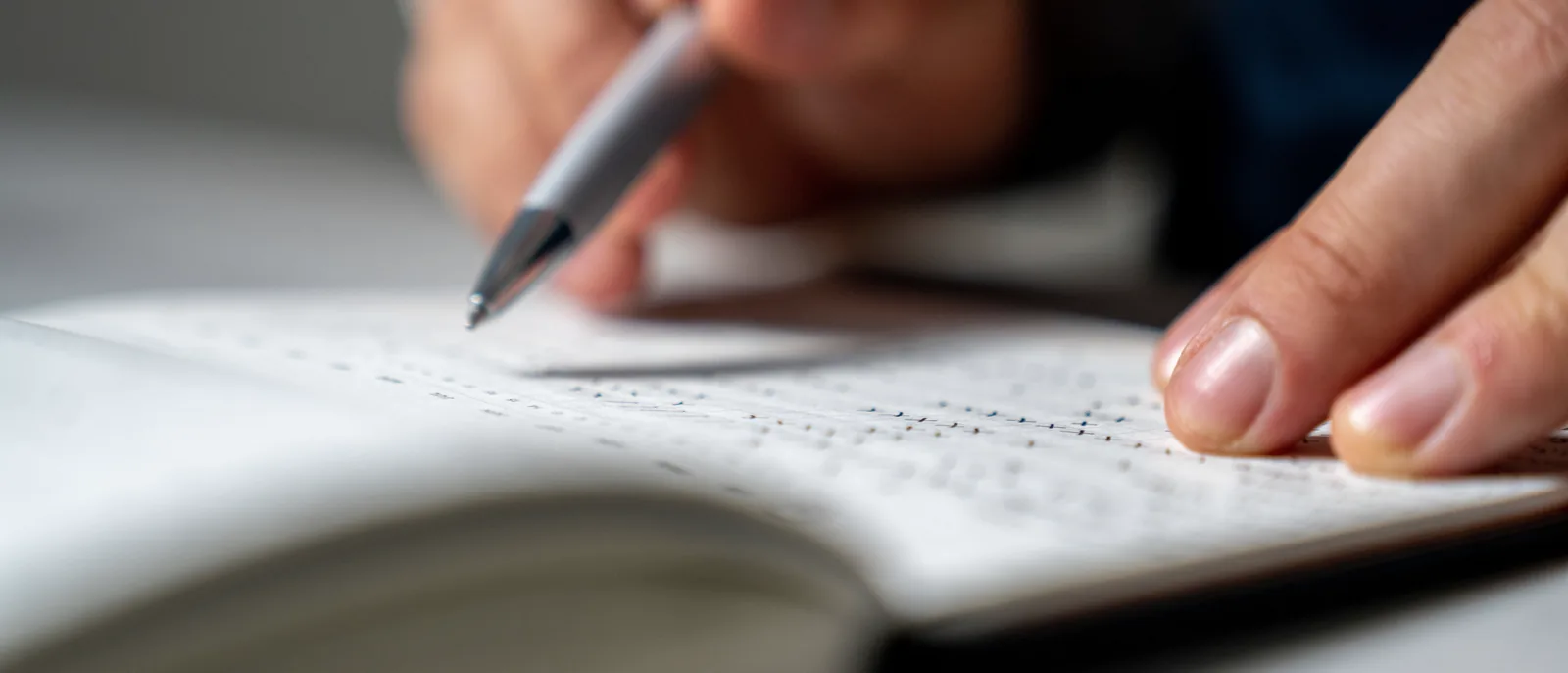 A business owner tracking his week in a notebook